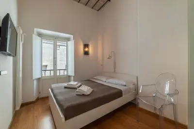 a bedroom with a bed with two towels on it at GuestHost - Cancelleria Rooftop Garden in Rome