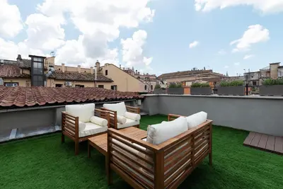 a patio with chairs on a roof at GuestHost - Cancelleria Rooftop Garden in Rome