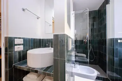a bathroom with a sink and a toilet and a mirror at Youcomehere - Montebello in Rome