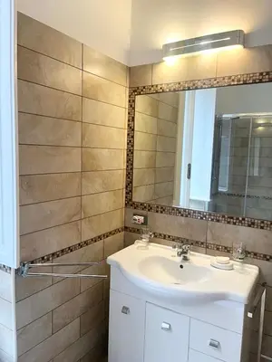 a bathroom with a sink and a mirror at Dolcevita’s House in Rome