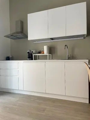 a kitchen with white cabinets and a sink at Cozy home close to the city center in Rome