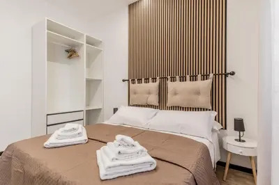 a bedroom with a bed with two towels on it at Casa Roma B&B in Rome