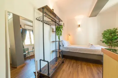 a room with a bed and a room with a mirror at Studio in Trastevere Village in Rome