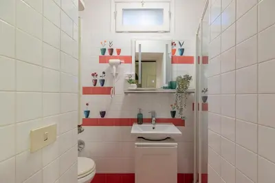 a bathroom with a sink and a toilet and a mirror at iFlat Comfy Apartament in Campo de' Fiori in Rome