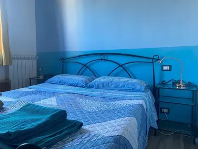 a blue bedroom with a bed with a blue wall at CASA PANIERI in Rome