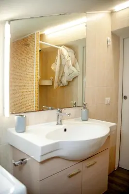 a bathroom with a white sink and a mirror at Magenta Terrione 2 in Rome