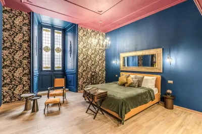 a bedroom with a bed and blue walls at Corso Miracle Suite in Rome