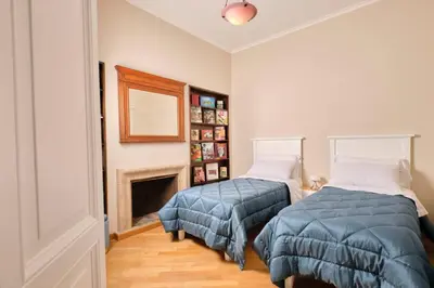 two beds in a room with a fireplace at La Torre di Castel Sant'Angelo in Rome