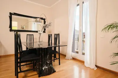a glass table and chairs in a room with a window at La Torre di Castel Sant'Angelo in Rome