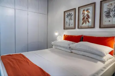 a bedroom with a bed with orange and white pillows at Accogliente intero appartamento in Rome
