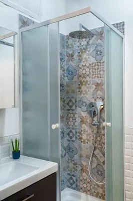 a shower with a glass door next to a sink at Accogliente intero appartamento in Rome