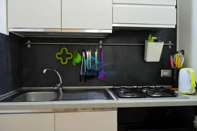 a kitchen counter with a sink and a stove at Pigneto Modern Apartment in Rome