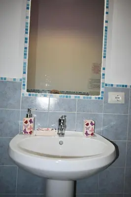 a white sink in a bathroom with a mirror at ACasaMiaSanPietro in Rome