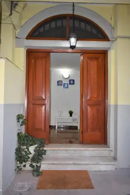 a large wooden door in a building with stairs at ACasaMiaSanPietro in Rome
