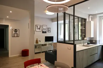 a kitchen and living room with a sink and a couch at Suite RHome In Vatican in Rome