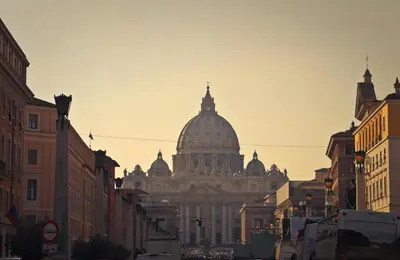 a large building with a domed building in the background at Suite RHome In Vatican in Rome