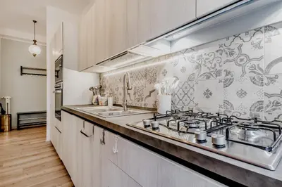 a kitchen with a sink and a stove at BBHOME History and design apartment in Testaccio district in Rome