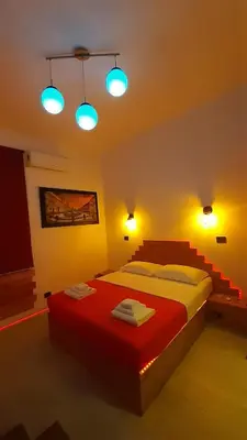 a bedroom with a large bed with blue lights at HARMONY RELAX HYDROMASSAGE SAUNA AT THE VATICAN MUSEUMS in Rome