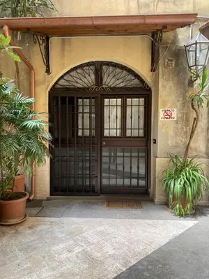 an entrance to a building with a black door at apartment vittorio Emanuele in Rome