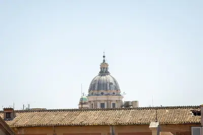 a domed building in the background with roofs at Corso View by Rental in Rome in Rome