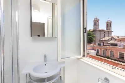 a bathroom with a white sink and a window at Corso View by Rental in Rome in Rome