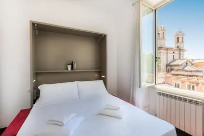 a bedroom with a white bed and a window at Corso View by Rental in Rome in Rome