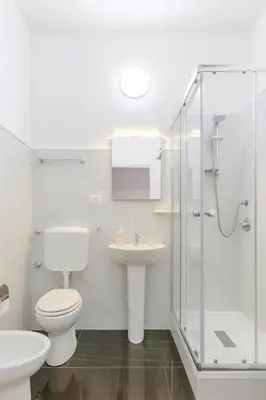 a bathroom with a toilet and a sink and a shower at Laura's Rooms a due passi dal Vaticano - RIONI DI ROMA in Rome