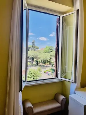 a window with a bench in front of a window at Crisalide Apartment in Rome