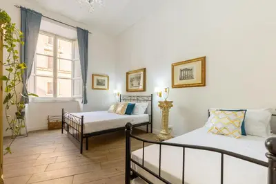 a room with two beds and a window at Ottaviano Suites in Rome