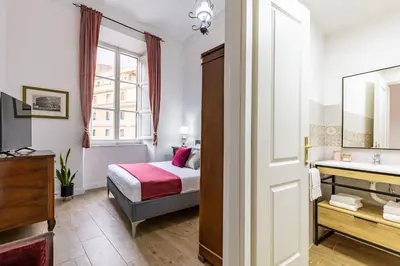 a hotel room with a bed and a sink at Ottaviano Suites in Rome
