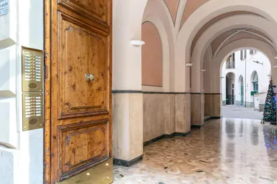 a hallway with a large wooden door in a building at Ottaviano Suites in Rome