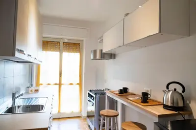 a kitchen with a sink and a stove top oven at Appartamento Appio Latino in Rome