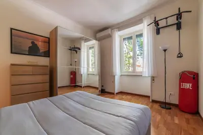 a bedroom with a large bed and two windows at GuestHost - Rione Prati Comfy Apartment in Rome