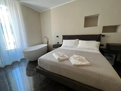 a bedroom with a bed with a bathtub and a bath tub at Viminale Domus in Rome