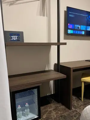 a bedroom with a bed and a tv on the wall at Viminale Domus in Rome