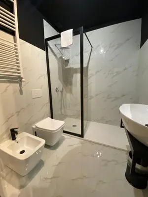 a room with two black doors and a table at Viminale Domus in Rome
