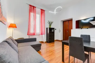 a living room with a couch and a table at King's House - San Giovanni/Re di Roma in Rome