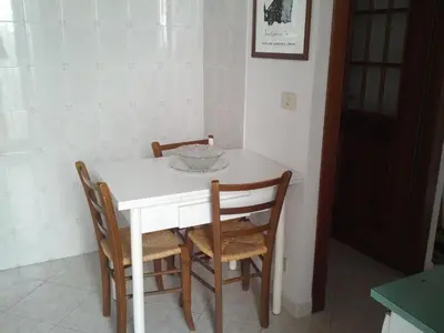 a white table and chairs in a room at Casa Vacanze Yuli in Rome