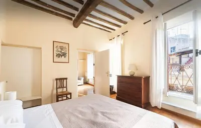 a bedroom with a bed and a large window at Piazza Navona Center House in Rome