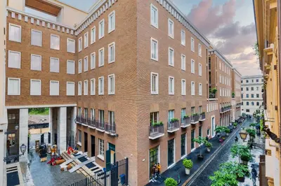 a large brick building with a courtyard in front of it at Frezza Charming Suite in Rome