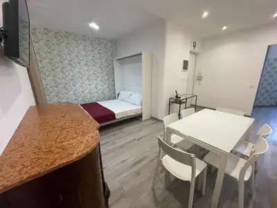 a small room with a bed and a table and chairs at Caracciolo33 in Rome