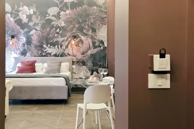 a bedroom with a bed and a painting of flowers at YCH-Butterfly Flat close Trevi Fountain in Rome