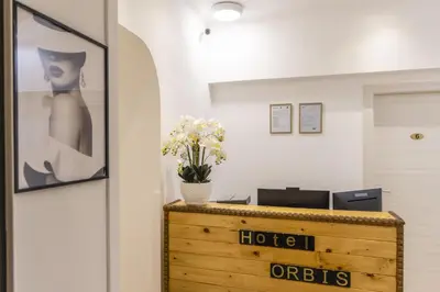an office with a desk with flowers on it at Hotel Orbis in Rome