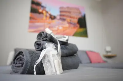 a pile of towels sitting on top of a bed at Big Flat Rome Metro C in Rome