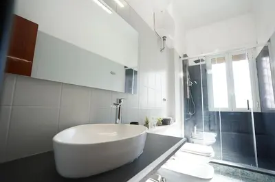 a white bathroom with a sink and a shower at Big Flat Rome Metro C in Rome