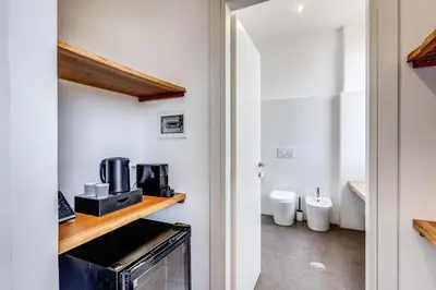 a kitchen with a microwave and a coffee maker on a counter at Effe Luxury Palace in Rome
