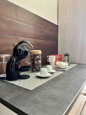 a counter top with a coffee maker and cups on it at Glory house Vatican Museum in Rome