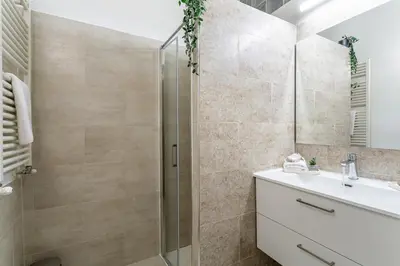 a bathroom with a shower and a sink at iFlat Blue Cozy Loft near Saint Peter in Rome