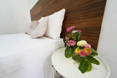 a room with a bed and a table with flowers on it at Rome Vatican City Whole Apartment 3 Private Rooms in Rome