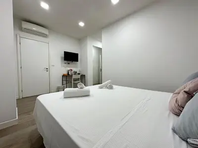a bedroom with a large white bed with towels on it at Rome Vatican City Whole Apartment 3 Private Rooms in Rome